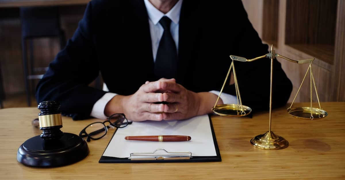 a brain injury lawyer sits behind a desk | Mandell, Boisclair and Mandell, Ltd
