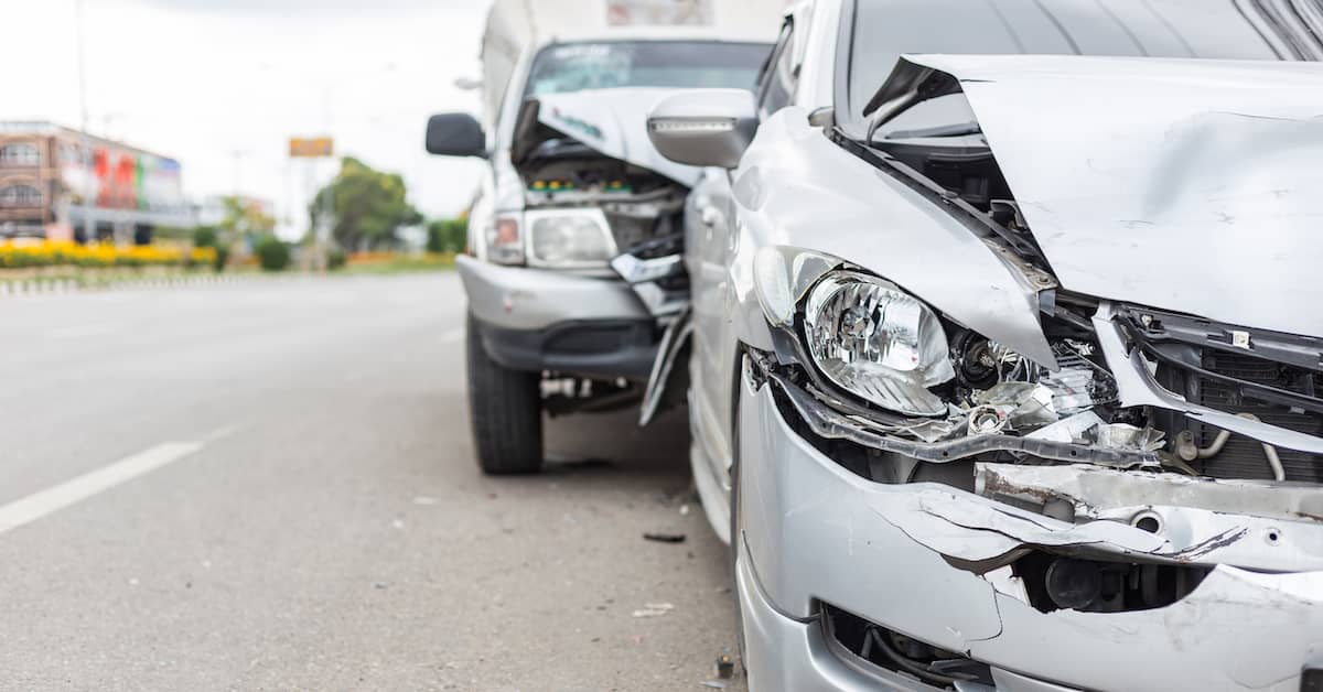 two cars on the side of a road after a crash | Mandell, Boisclair and Mandell, Ltd.