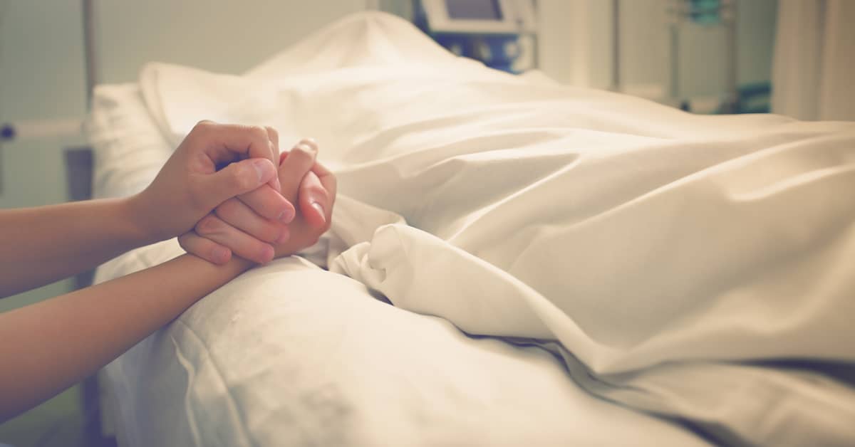 a person holds the hand of someone who passed away on a hospital bed | Mandell, Boisclair and Mandell, Ltd.