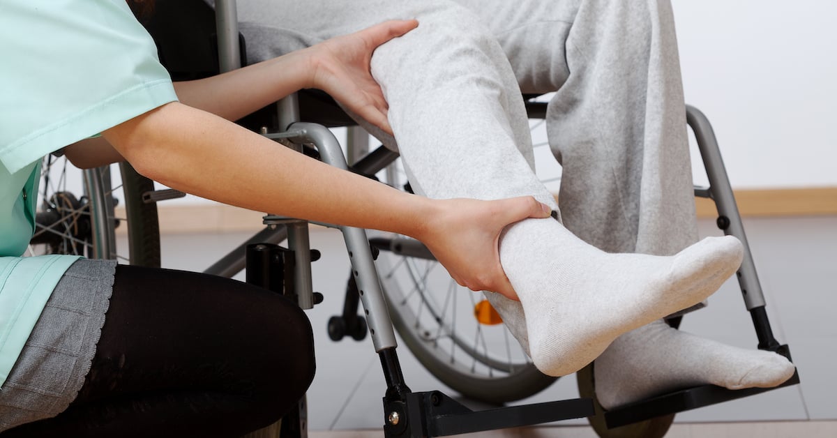 a nurse helps someone in a wheelchair | Mandell, Boisclair and Mandell, Ltd.